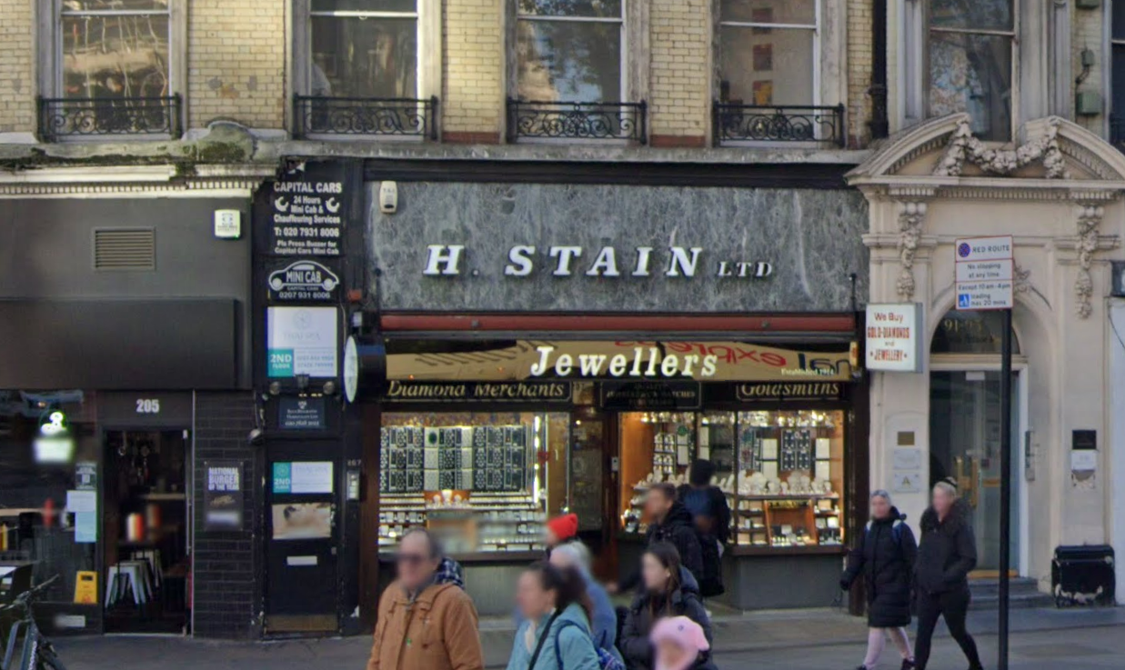 H. STAIN LTD Jewellers, prominently displaying signage in the same kind of font to the Royal Festival Hall. Some parts of the image are blurred as it’s a screenshot from Google streetview. 