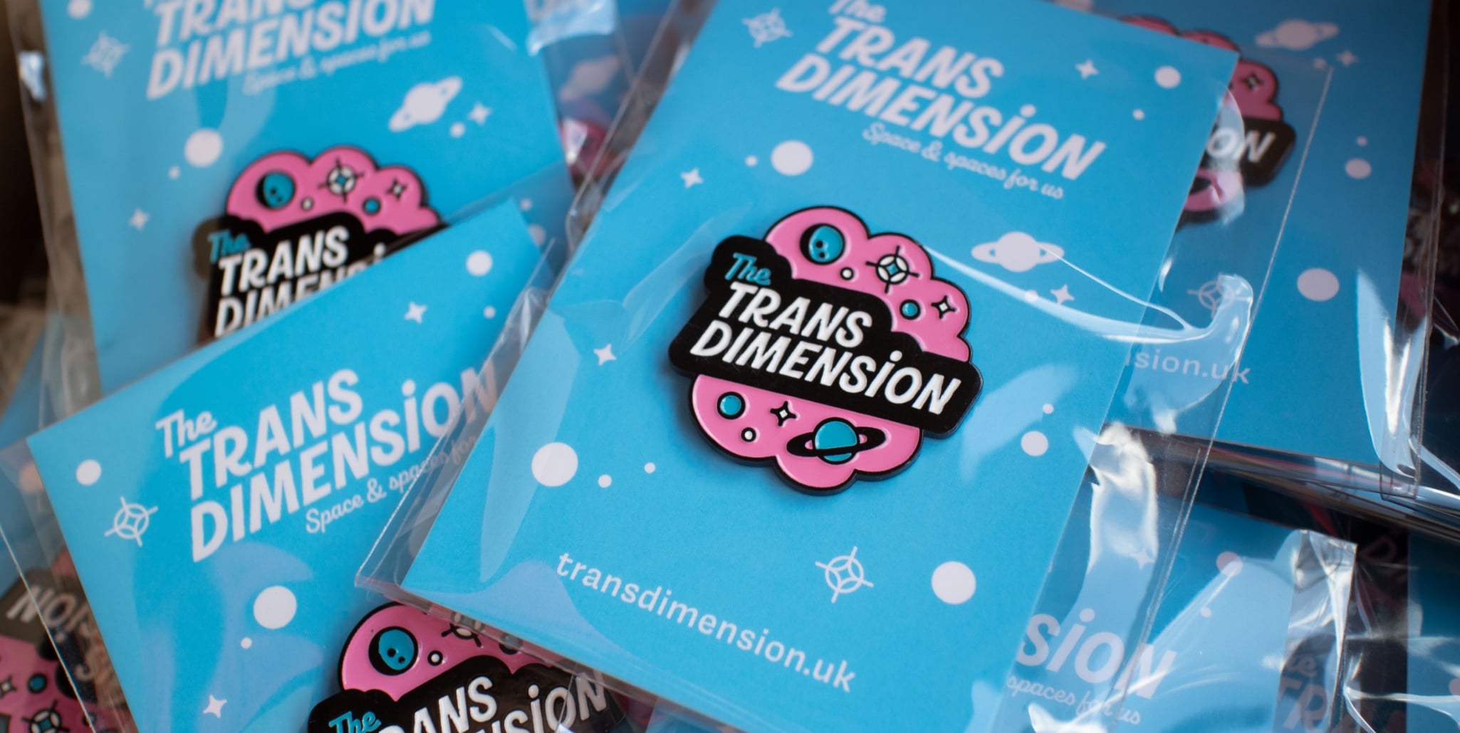 A photograph of The Trans Dimension pin badges